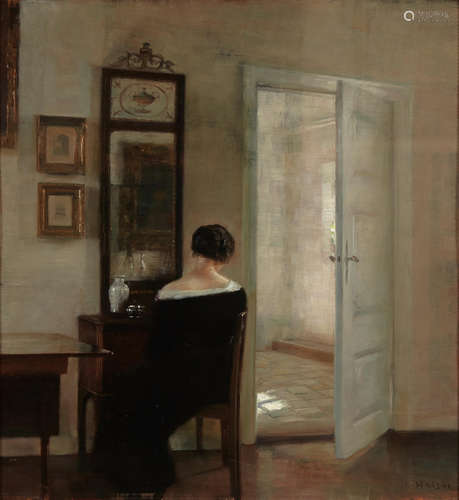 Carl Vilhelm Holsøe (Danish, 1863-1935) A lady seated before a mirror in an interior 22 7/8 x 21 1/4in (58.2 x 54cm)