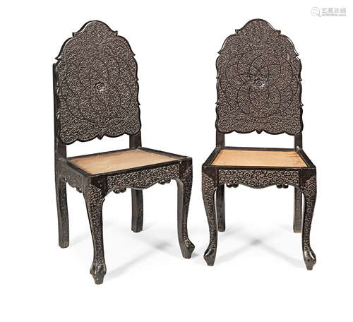 A pair of Anglo-Indian 19th century carved ebonised chairs