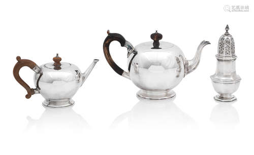 Two bullet style modern silver teapots, and a sugar caster the largest by Garrard & Co, London 2014, the smaller by Mappin & Webb, London 1964 (3)