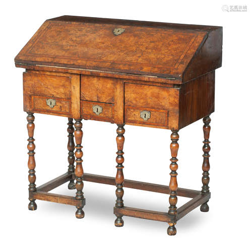 A William and Mary and later walnut cross banded and inlaid bureau on stand