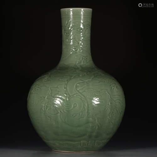 A Chinese Pea Green Glazed Dragons Carved Porcelain Vase