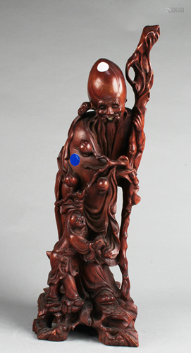 A Carved Wooden Deity Statue