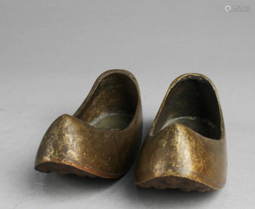 A Pair of Bronze Shoe Display