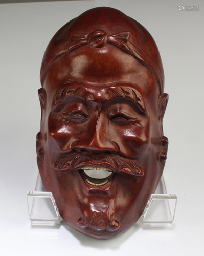 A Carved Wooden Face Mask Ornament