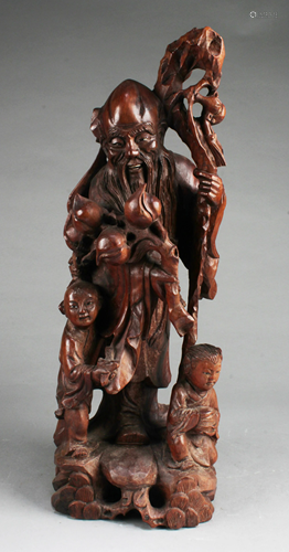 A Carved Wooden Deity Statue