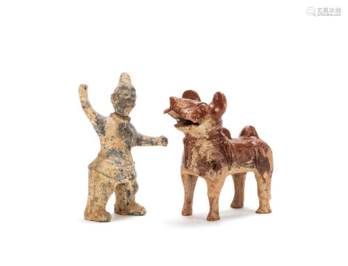 A grey pottery model of a warrior and a russet glazed pottery model of a dog Han Dynasty