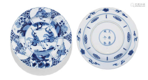 A pair of blue and white 'hunting' foliate-rimmed dishes Kangxi six-character marks and of the period