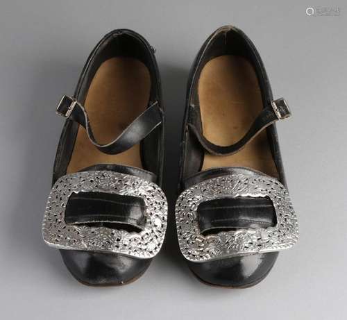 Shoes with silver buckles