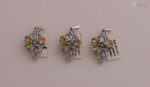 3 Silver pendants with colored stones.