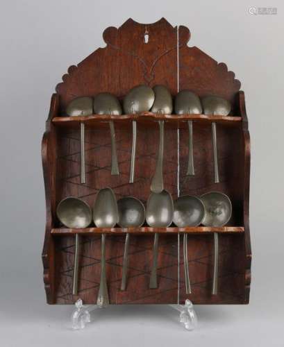 Rack with 12 pewter spoons