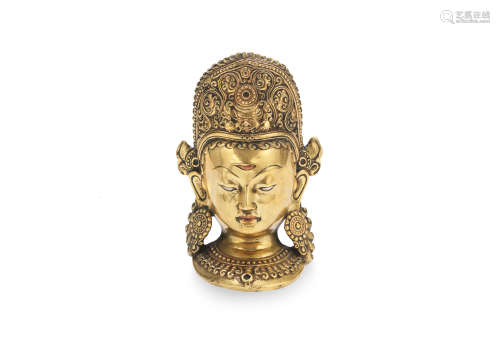 A silver and copper inlaid repoussé bronze mask of Indra  Nepal