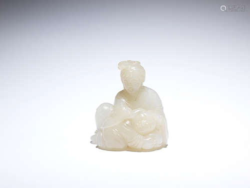 A white jade carving of a lady and a boy