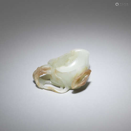 A pale green and mushroom coloured jade 'lotus' washer  Song/Ming Dynasty