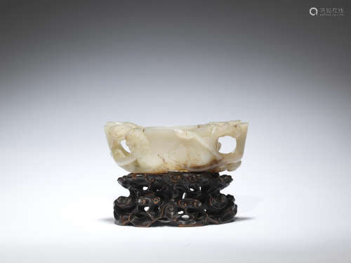 A white and mushroom jade 'lingzhi, lotus and prunus' reticulated cup  Ming Dynasty