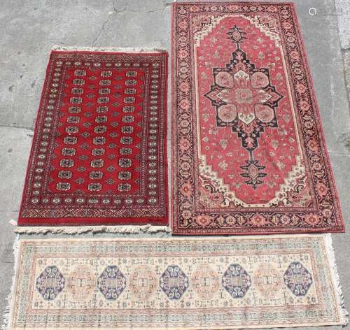 Property of a lady of title - three assorted rugs including a hand woven Turkoman design rug,