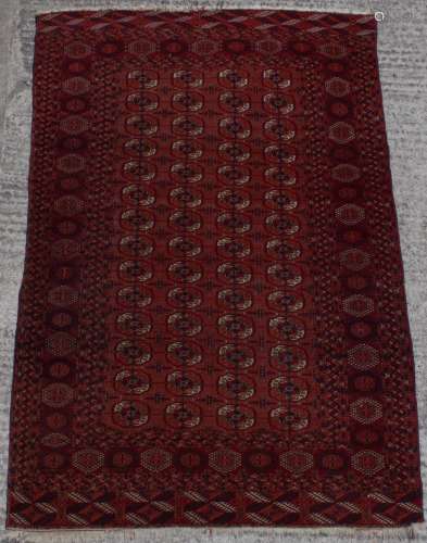 Property of a deceased estate - a Turkoman rug with four rows of guls, 83 by 55ins. (211 by