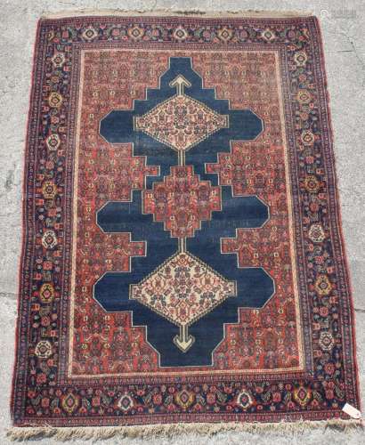 Property of a lady of title - a Persian Senneh rug, 77 by 53ins. (196 by 135cms.).