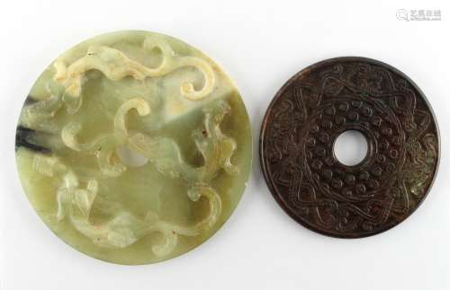Property of a gentleman - two modern Chinese carved jade bi discs, the larger 5.9ins. (15cms.)