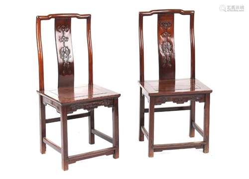 A pair of Chinese hongmu side chairs, late 19th century, the backs carved with a bat above twin fish