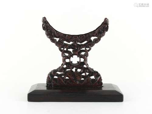 A Chinese zitan bi disc stand, 19th century, carved with five bats, 6.25ins. (16cms.) high.