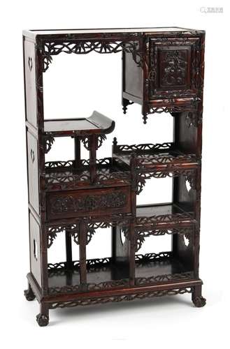 A late 19th century Chinese carved hongmu display cabinet of small size, fitted with a door, a