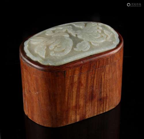 A 19th century Chinese hongmu oval box, the cover inset with a pale celadon jade panel carved in