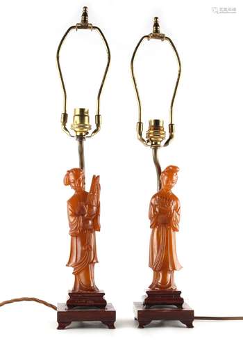 Property of a lady - a pair of Chinese carved amber style figures of ladies, mounted as table lamps,