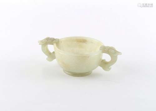 Property of a deceased estate - a Chinese carved pale celadon jade two handled cup, late Qing