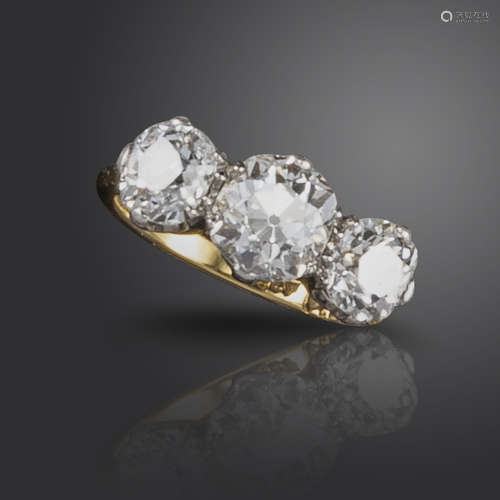 A diamond three-stone ring, set with three old cushion-shaped diamonds weighing approximately 3.