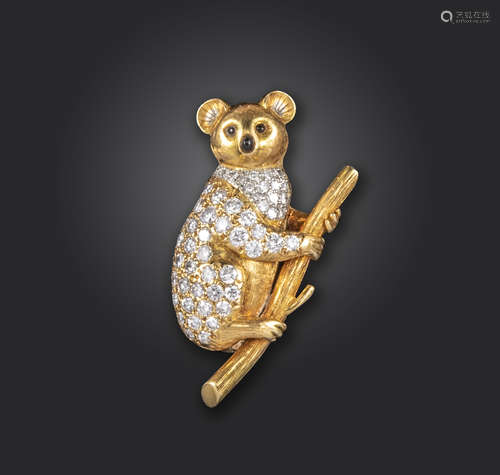 A diamond-set gold koala brooch, the stylised koala pave-set with diamonds, climbing a eucalyptus