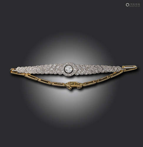 An Edwardian diamond bracelet, set with a central old circular-cut diamond within articulated