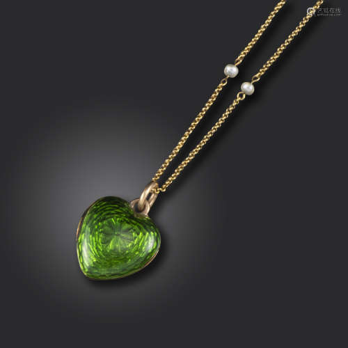 A Victorian green enamel heart-shaped locket pendant, opening to reveal a glazed compartment