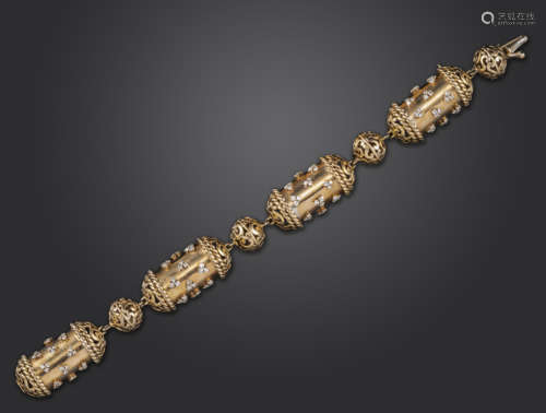 A diamond-set gold bracelet, the stylised cylindrical links set with diamond trefoils with pierced