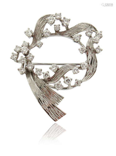 A diamond scroll brooch, set with round brilliant-cut diamonds in textured white gold, 4cm high