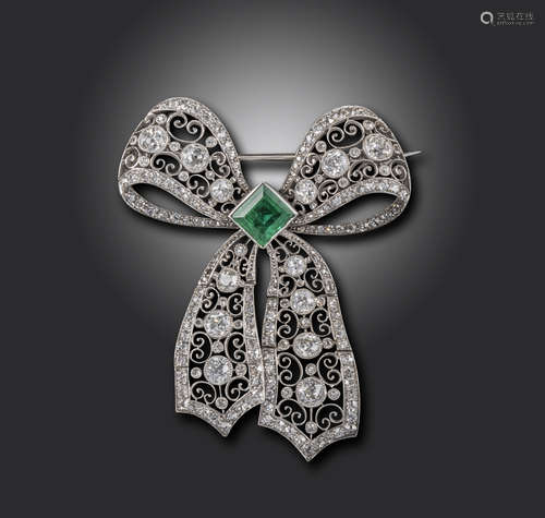 A Belle Epoque emerald and diamond bow brooch, the square emerald set within stylised pierced and