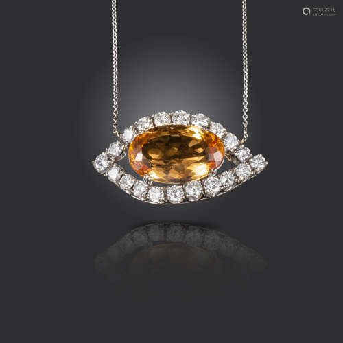 An orange topaz and diamond pendant, the oval-shaped topaz set within a lozenge-shaped surround of