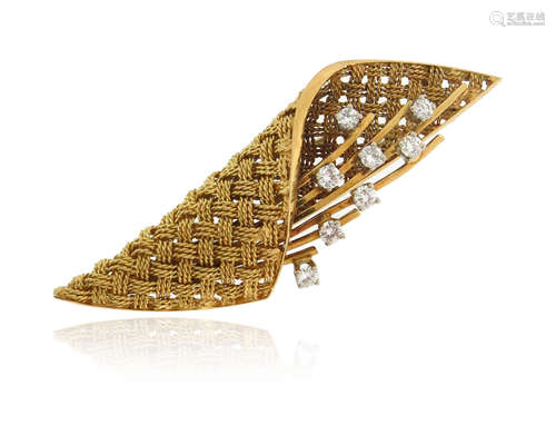 A stylised gold basket brooch, the woven gold fabric containing a stylised floral sprig decorated