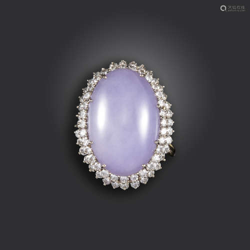 A French lavender jade and diamond ring, the jadeite jade cabochon set within double surround of