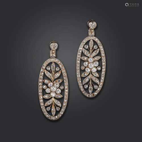 A pair of diamond-set drop earrings, the oval-shaped drops of openwork design, with foliate motif