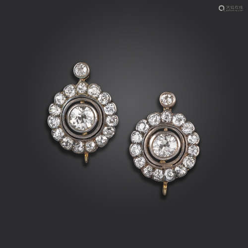 A pair of diamond cluster earrings, each old circular-cut diamond set within a surround of further