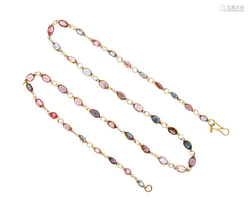 A gem-set gold long chain, set with oval-shaped spinels and sapphires in yellow gold spectacle