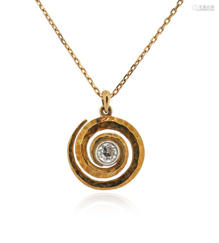 A diamond set gold pendant, the hammered gold swirl centred with an old circular-cut diamond