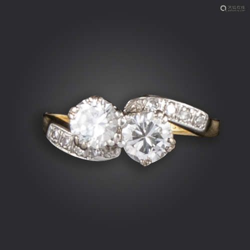 A diamond crossover ring, set with two round brilliant-cut diamonds weighing approximately 0.60cts