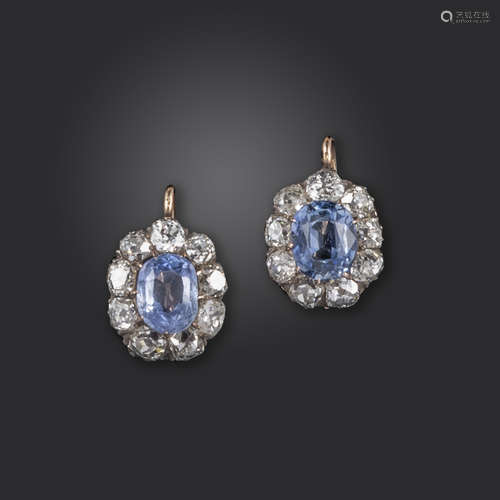 A pair of sapphire and diamond cluster earrings, the oval sapphires are each set within a surround