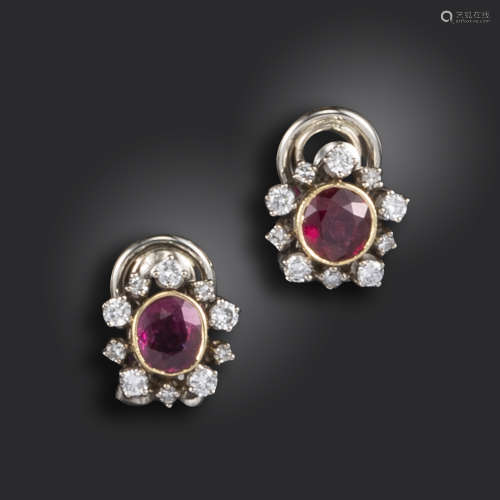 A pair of ruby and diamond cluster earclips, the circular rubies set within alternating smaller