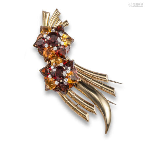 A citrine and diamond spray brooch, c1940, mounted with two foliate clusters set with deep orange