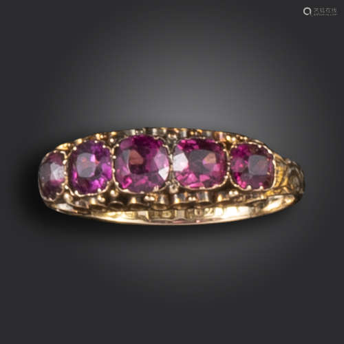 A Victorian garnet five-stone ring, set with cushion-shaped garnets in a gold scrolling mount,