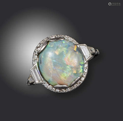 An Art Deco opal and diamond cluster ring, the oval-shaped opal set within a surround of small