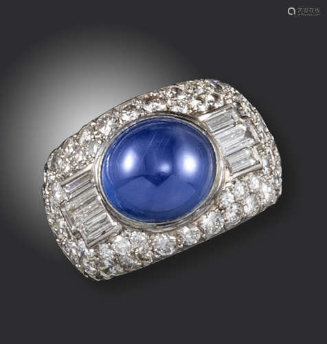 A star sapphire and diamond bombé ring, set with an oval star sapphire, pavé-set with circular-cut