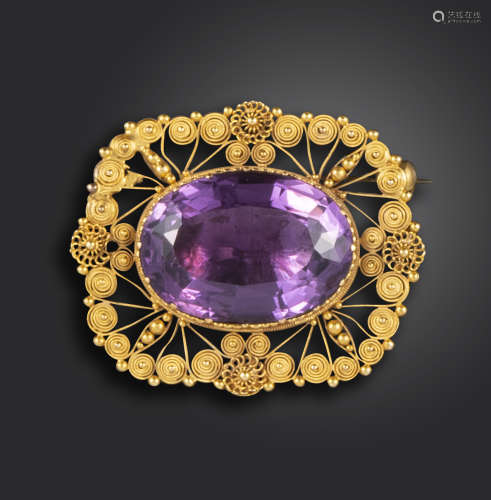 A Regency amethyst gold brooch, the oval amethyst set within cannetille surround in closed-back